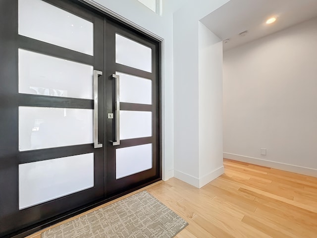 entryway with french doors and hardwood / wood-style flooring