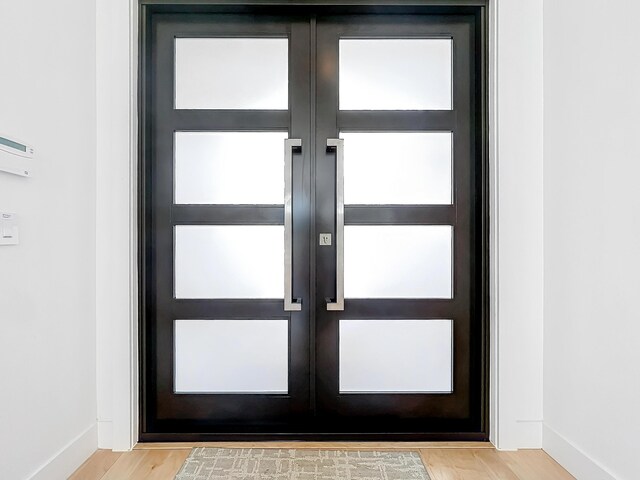 doorway to outside with light hardwood / wood-style flooring and french doors