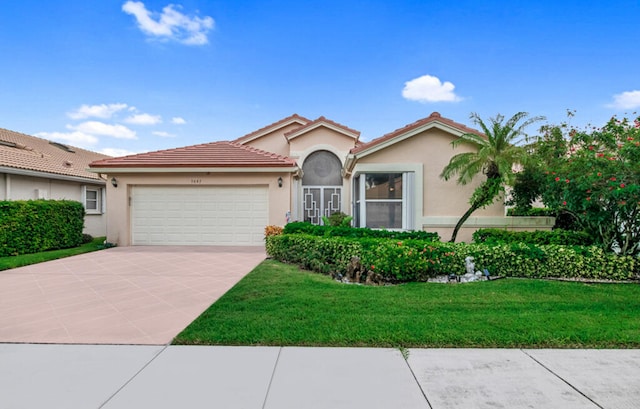 view of front of home featuring a garage and a front yard