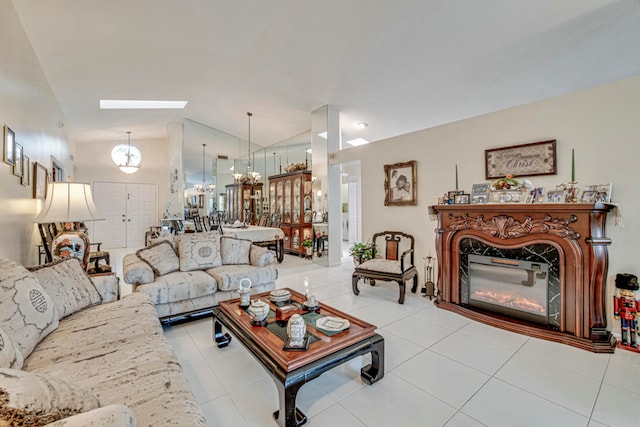 living room with a skylight, an inviting chandelier, and light tile patterned floors