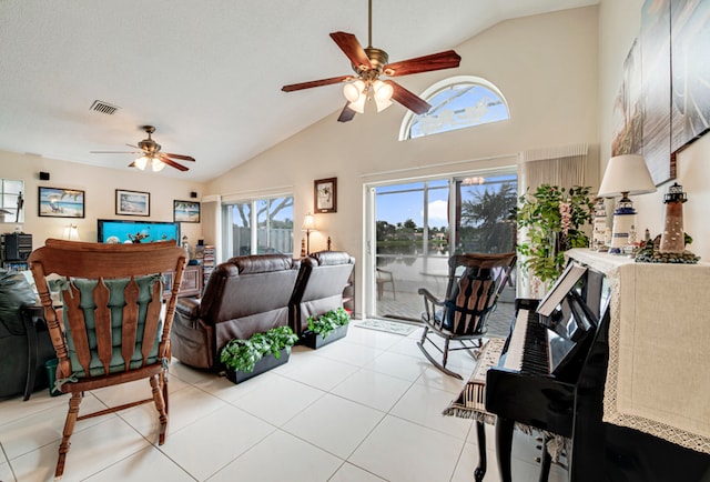 tiled living room with high vaulted ceiling, ceiling fan, and plenty of natural light