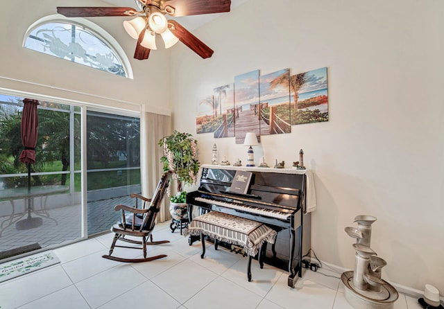 miscellaneous room with a high ceiling, ceiling fan, and light tile patterned floors