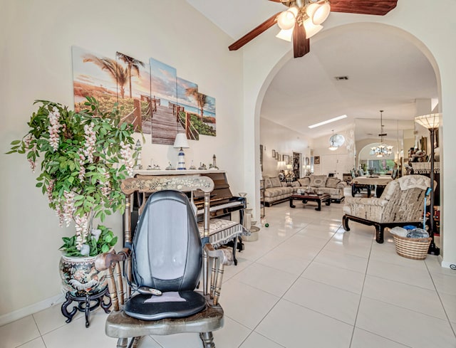 interior space featuring vaulted ceiling, ceiling fan, and light tile patterned floors