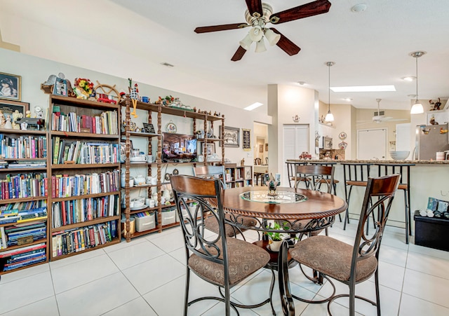 tiled dining room featuring vaulted ceiling and ceiling fan