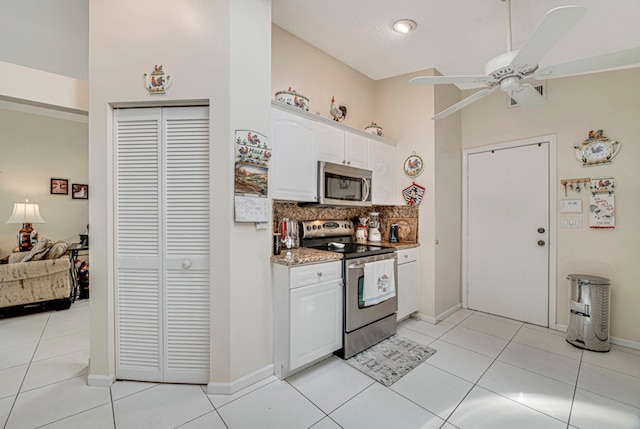 kitchen with white cabinetry, decorative backsplash, appliances with stainless steel finishes, light tile patterned floors, and ceiling fan