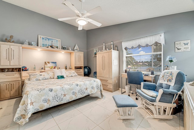 bedroom featuring ceiling fan and a textured ceiling