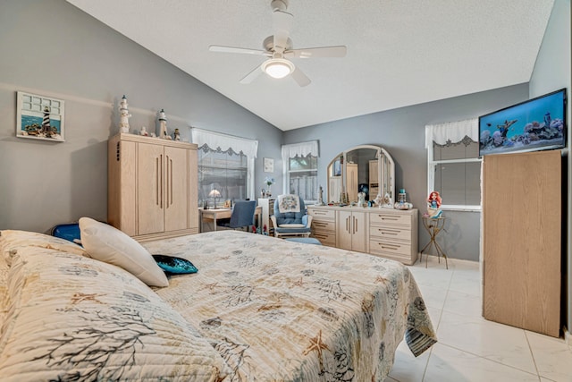 bedroom featuring vaulted ceiling, ceiling fan, and a textured ceiling