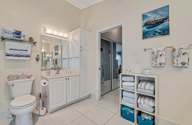 bathroom with vanity, toilet, and tile patterned floors