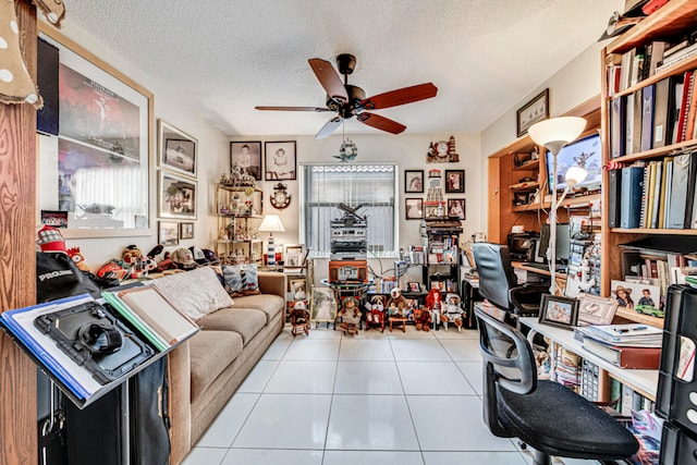 office space with a textured ceiling, light tile patterned floors, ceiling fan, and a wealth of natural light