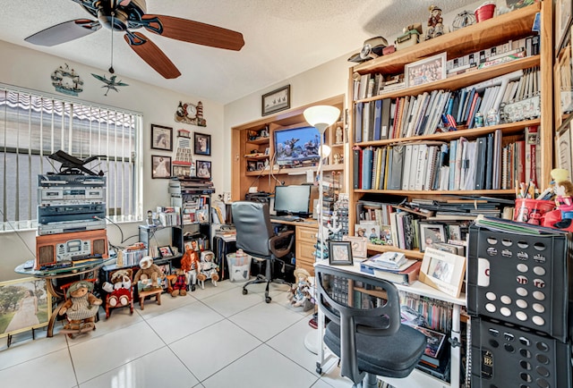 home office with ceiling fan, tile patterned floors, and a textured ceiling