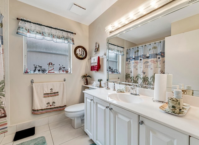 bathroom with vanity, toilet, and tile patterned floors