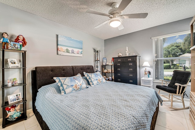 bedroom with ceiling fan and a textured ceiling