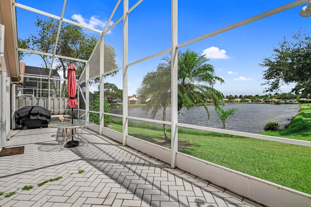 unfurnished sunroom featuring a water view