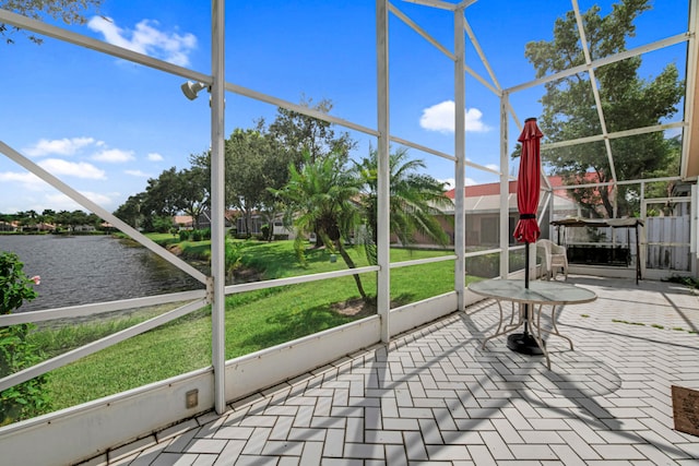 unfurnished sunroom with a water view