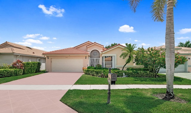 mediterranean / spanish-style house featuring a garage and a front lawn