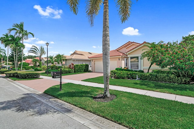 view of front facade with a garage and a front lawn