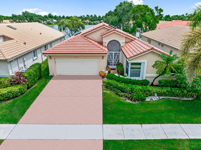 mediterranean / spanish-style home with a garage and a front yard