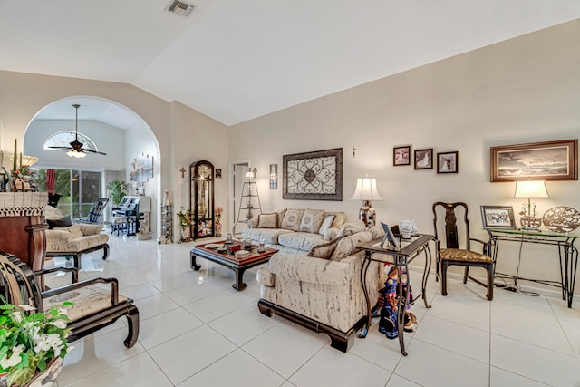 tiled living room featuring lofted ceiling and ceiling fan