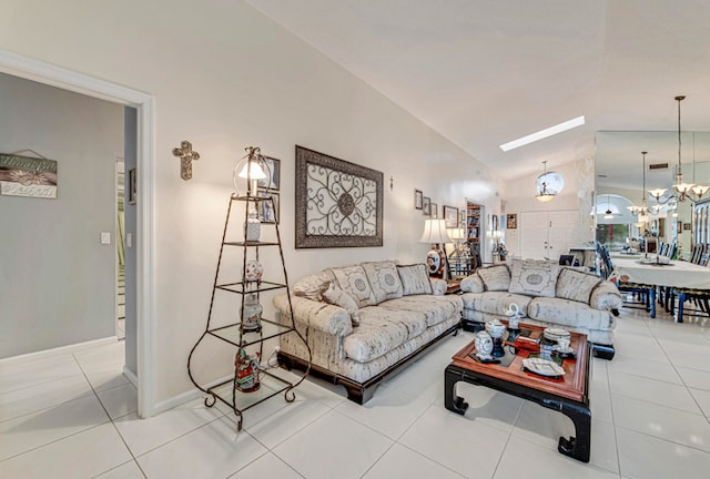 living room with lofted ceiling, an inviting chandelier, and light tile patterned floors