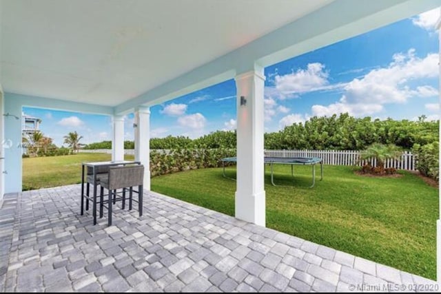 view of patio / terrace with fence and a trampoline