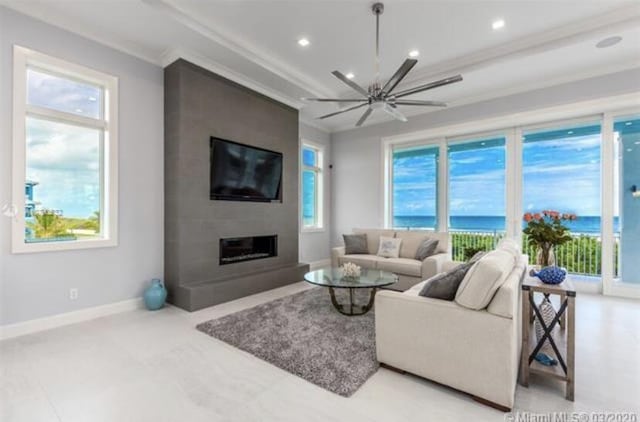 living area with baseboards, a ceiling fan, crown molding, recessed lighting, and a large fireplace