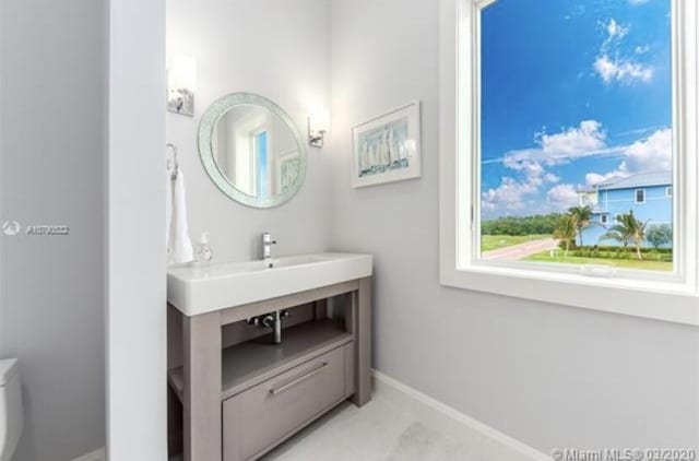half bath with toilet and baseboards