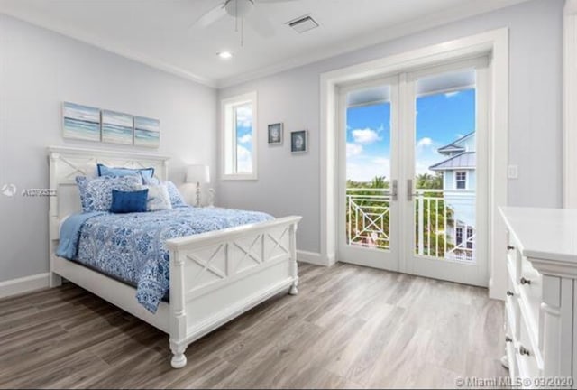 bedroom featuring light wood-type flooring, access to exterior, baseboards, and visible vents