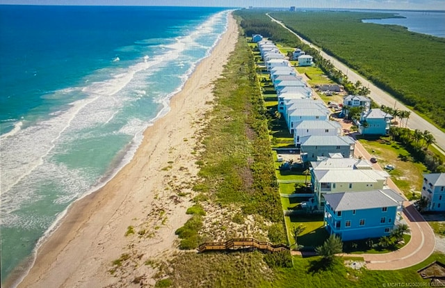 birds eye view of property with a beach view and a water view