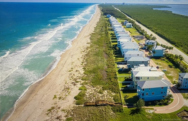 drone / aerial view with a water view and a view of the beach