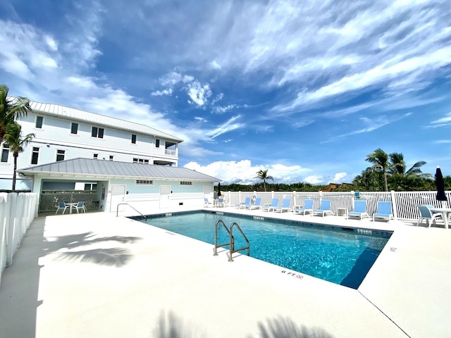 pool featuring a patio area and fence