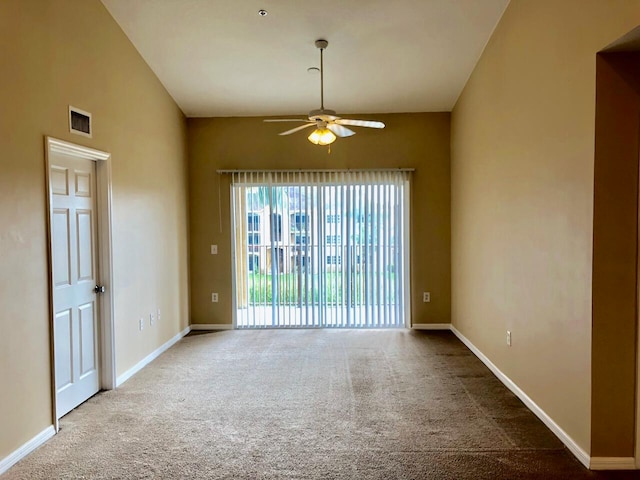 empty room with lofted ceiling, ceiling fan, and carpet floors