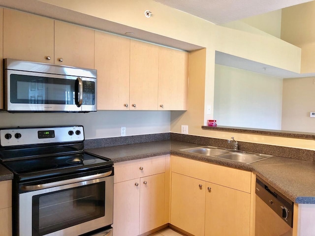 kitchen featuring stainless steel appliances, sink, and light brown cabinets