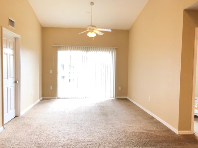 empty room with light carpet, vaulted ceiling, and ceiling fan