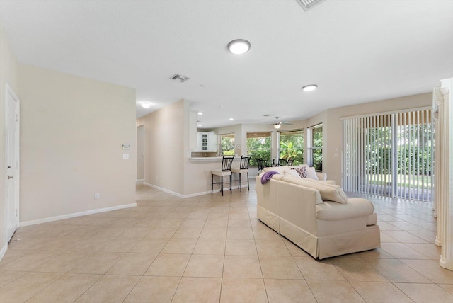 living room featuring ceiling fan and light tile patterned floors