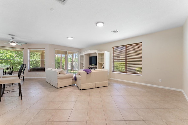 living room featuring light tile patterned flooring and ceiling fan