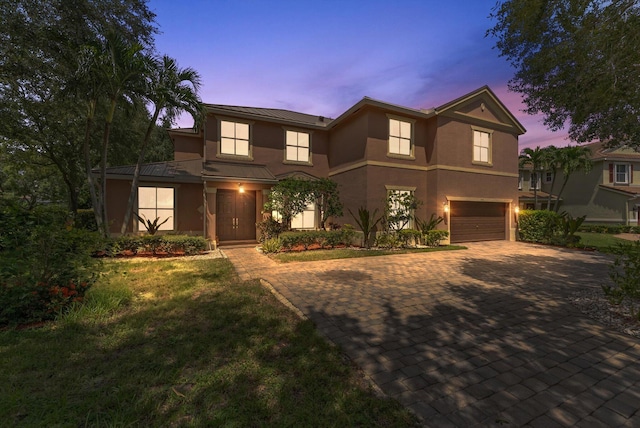 view of front of home featuring a yard and a garage