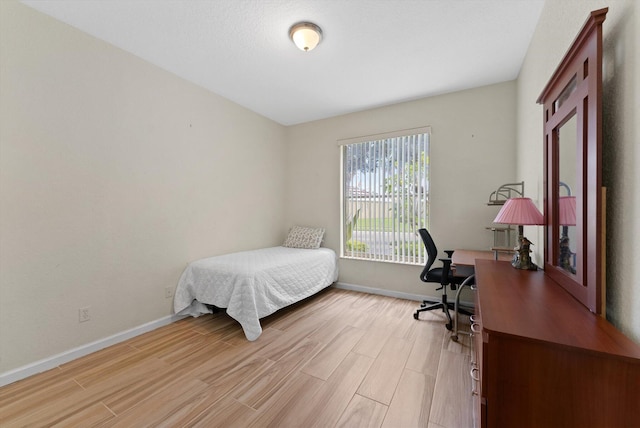 bedroom with light hardwood / wood-style floors