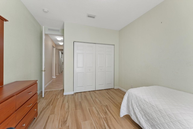 bedroom featuring light hardwood / wood-style floors and a closet