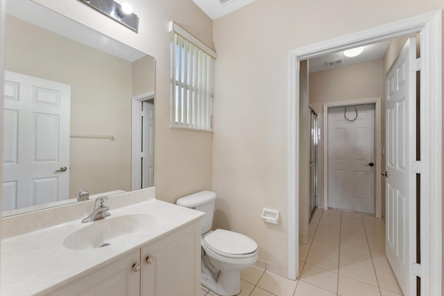 bathroom featuring vanity, tile patterned floors, and toilet