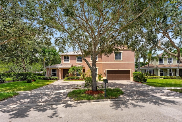 view of front of property with a garage and a front lawn