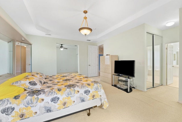 bedroom with ensuite bath and carpet flooring