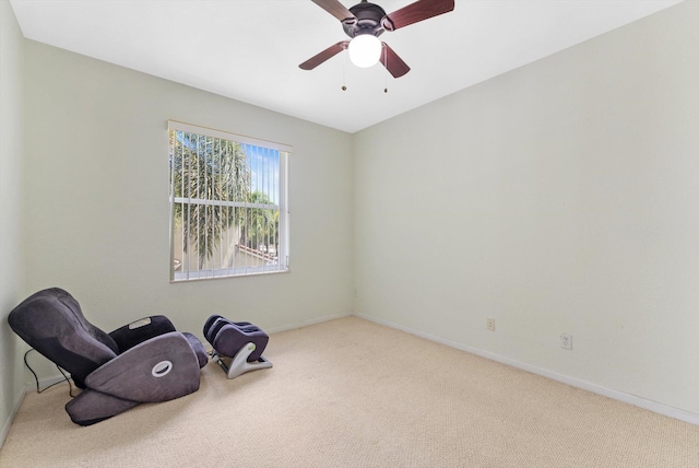 living area featuring ceiling fan and light colored carpet