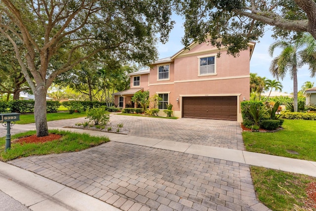 view of front facade with a front yard and a garage