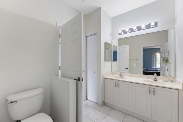 bathroom with tile patterned flooring, vanity, and toilet