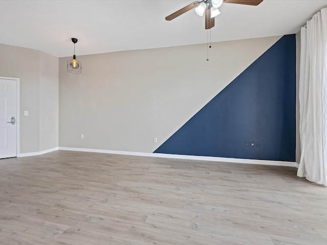 spare room featuring ceiling fan and light hardwood / wood-style floors