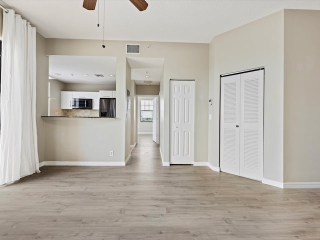 unfurnished living room with light hardwood / wood-style flooring and ceiling fan