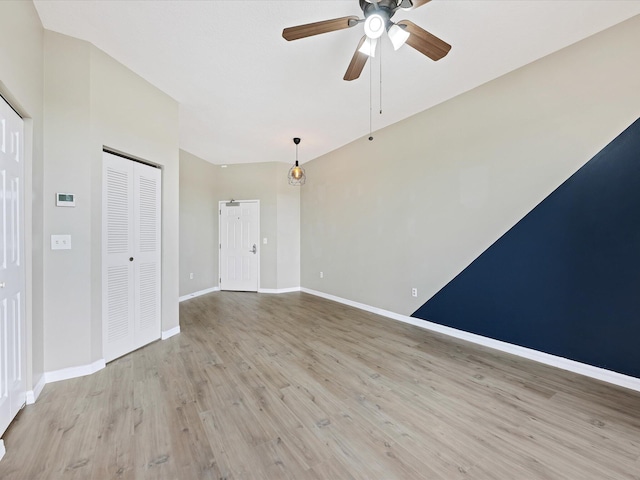 empty room featuring ceiling fan and light hardwood / wood-style floors