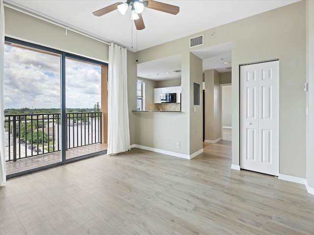 unfurnished living room with light hardwood / wood-style flooring and ceiling fan