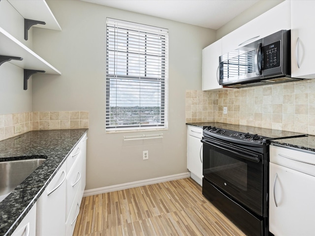 kitchen featuring electric range, decorative backsplash, a healthy amount of sunlight, and white cabinetry