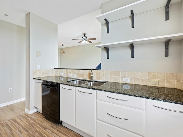 kitchen featuring white cabinetry, dishwasher, ceiling fan, sink, and dark stone counters